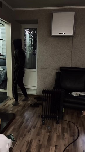 Stylish Indoor Walk: Black Leather Jacket Movement