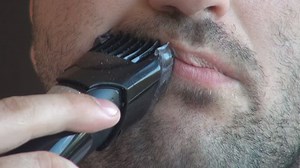 Closeup dry shaving, adult using professional tools for morning manly healthcare