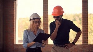 Real Estate Building Project Architect.Builder Constructor Read Blueprints.Developer On Construction Site.Civil Engineer Architect On Development.Foreman Engineer Builder In Helmet Inspecting Building