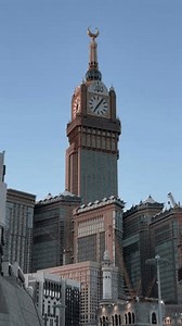 Makkah, Kingdom of Saudi Arabia - 29.01.2024: Overview of the Clock Towers. Camera movement from top to bottom of the building.
