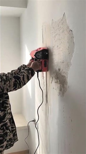 Electric scraper strips wall surface, old paint removed cleanly