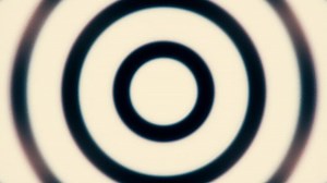 Black and white zooming circles, seamless loop. Animation. Simple geometric motion graphics monochrome background, widening circles making a signal.