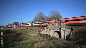 COLWICH, STAFFORDSHIRE, ENGLAND - JANUARY 26 2024: Passenger train travelling over a railway bridge on the West Coast mainline railway.