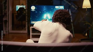 African american man plays spaceship science fiction singleplayer game with overlay HUD showing health bars and minimap. Zoom in shot of gamer enjoying high quality ray tracing graphics in videogame