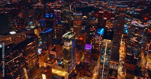 Spectacular modern high-rise buildings in downtown Houston, Texas, USA. Vibrant city panorama with lively traffic at night.