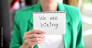 HR manager shows an ad with the message that we are hiring