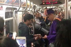 Subway riders throw 'graduation' for college student stuck on train