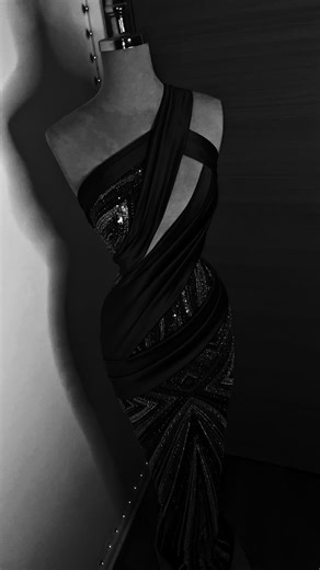 @arianurcouture on Instagram: "A sculpted statement in deep ruby. Liquid satin drapes across the body in bold, architectural folds, revealing a corseted core fully hand-embellished with intricate rhinestones and beads. The geometric crystal pattern elongates the silhouette, while the asymmetrical neckline adds tension and drama. This is not just a gown — it’s controlled seduction with couture precision. #CoutureGown #LuxuryEveningWear #HauteCoutureDesign #RedCarpetReady #statementsilhouette"