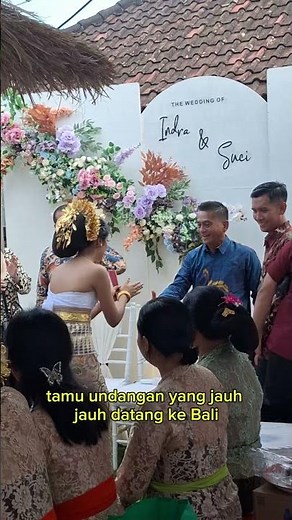 The atmosphere of a traditional Balinese wedding reception, when the bride and groom and their fa...