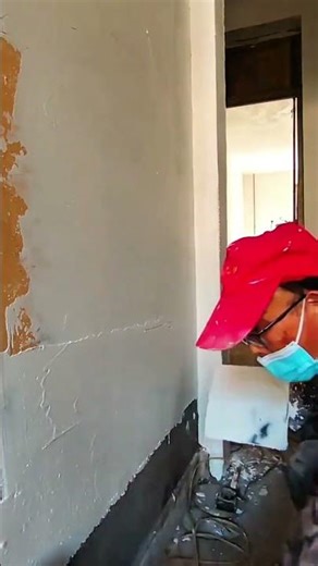 Applying plaster smoothly to wall surface during renovation