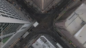 Aerial: Time Lapse of trains moving on elevated railway tracks over street amidst buildings in city - Chicago, Illinois
