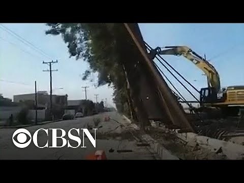 Part of U.S. border wall falls over into Mexico