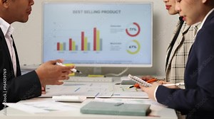 Analyzing sales performance charts in a corporate meeting. Business professionals discussing sales performance charts and top-selling products in a corporate meeting.