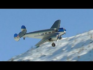 Old Beechcraft Model 18 Twin over Snowy Swiss Engadine Valley