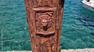 fragment of a rusty lighthouse pole at a sea pier, Kokkala, Mani peninsula beach, Greece