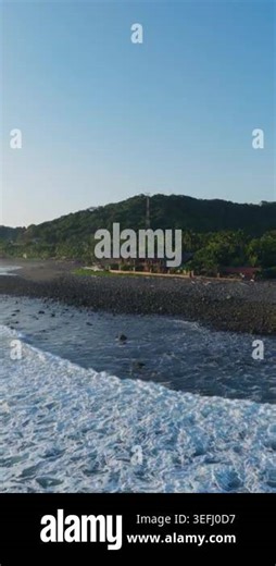 Tranquil Coastline of El Salvador Low-Rise Buildings and Communication Tower Amidst Natural Beauty Stock Video Footage - Alamy
