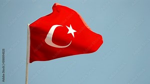 turkish red flag on blue sky under wind in sunny day, turkey travel diversity