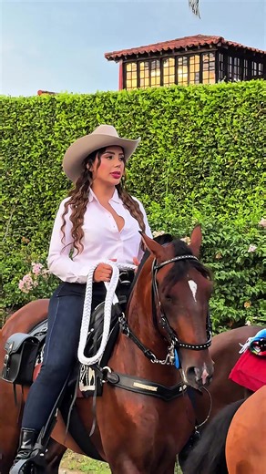 A beautiful Latina rides her horse gracefully to the vibrant rhythm of popular music.