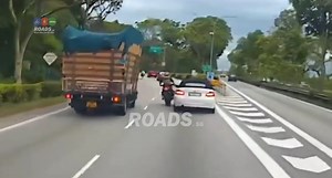 503K views · 1.1K reactions | Lane splitting motorcyclist gets sandwiched by a car and lorry. The rider could have got himself in a serious accident. | ROADS.sg | Facebook