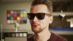 Graded and balanced by ColorChecker. Man testing professional film camera. ColorChecker Gray Scale, Classic Card and spidercube. It helps to ensure eccurate color balance. RED MONSTRO, Lens 50 mm