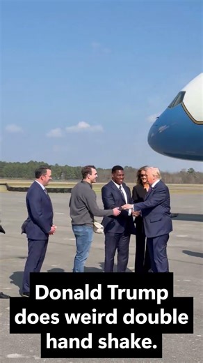Donald Trump does weird double hand shake.
