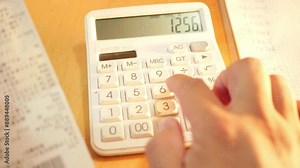 Accountant calculating with a calculator on a desk. Close up of an accountant hands calculating with a calculator on a desk,4k