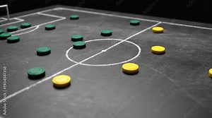 Abstract Soccer Strategy: Green and Yellow Tokens on a Dark Chalkboard Field Representing Teams and Formations, Conceptual Game Plan