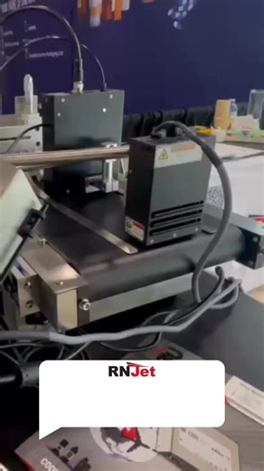 See the RNJet 72 deliver sharp, durable codes using UV-curable ink on a friction feeder system — fast, clean, and built for industrial performance. 💪 #RNJet #UVPrinting #InkjetPrinter #CodingAndMarking #IndustrialPrinting #SmartManufacturing #PackagingSolutions #UVInk #ProductMarking #RNJet72 | RN Mark Inc