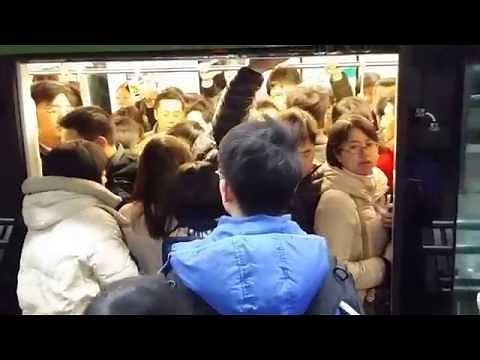 Chinese Ayi gets packed into metro train.
