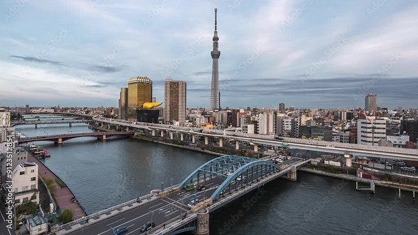 Timelapse of the Sumida River and Tokyo skyline in Sumida City, Tokyo, Japan, zooming in.