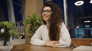clip-3455413703-curly-girl-glasses-on-date-drinking-white
