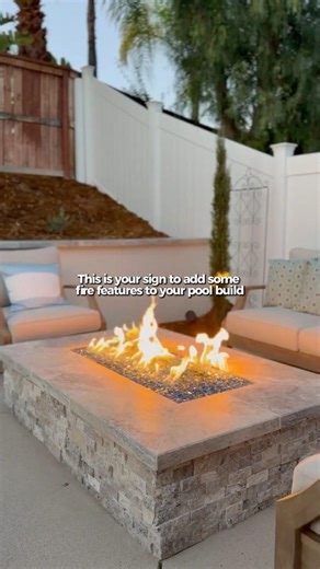 This is your sign to add some fire features to your pool build