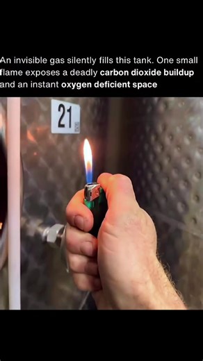 A lighter moves toward the open hatch of a wine fermentation tank, and the flame instantly disappears the moment it reaches the opening. It relights easily in open air, but near the tank it cannot survive for more than a split second. As yeast converts sugars into alcohol, it releases large volumes of carbon dioxide. That gas is heavier than air, so it settles and accumulates inside the tank, quietly pushing oxygen out of the space. From the outside, everything looks completely normal. Fire need