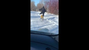 One-legged man rides bicycle using crutches in Nikolayevka, Russia