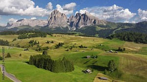 Seiser Alm, Alpe di Siusi aerial view at Summer in Italian Dolomites, South Tyrol, Trentino Alto Adige, Italy. Val Gardena valley, wooden hut lodge, Sassolungo Langkofel alpine mountain