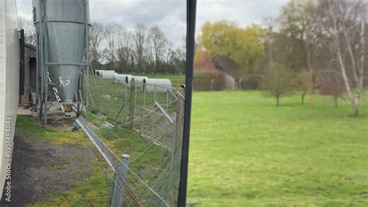 Traditional oast house across green pasture panning