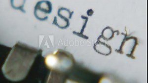 Typing "set design" on an old typewriter