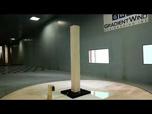 Real-time aeroelastic hybrid simulation of a base pivoting model building in a wind tunnel