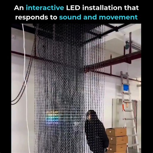 AI | Technology | Education on Instagram: "you’re seeing is an interactive LED bead installation that creates the illusion of a floating volume of light, reacting in real time to human movement. Each bead acts as a precise data point in 3D space. Sensors track motion, software interprets it, and algorithms translate that input into light patterns that shift instantly as people move through the installation. The result feels alive, but it’s the product of tight coordination between hardware, soft