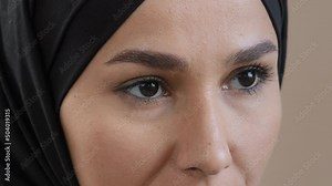 Extreme close up female eyes arabian saudi islamic woman model face with perfect skin natural makeup in traditional hijab look straight wink eyelashes good vision after ophthalmology laser operation