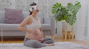 Happy Pregnant woman using virtual reality glasses for practice tutorial to take care of a newborn baby.Asian Pregnant woman ware goggle using virtual reality or VR enjoy at home.Pregnancy Technology