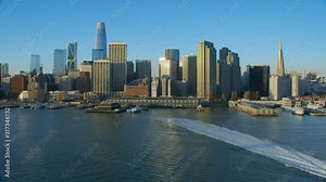 Aerial view of the San Francisco Ferry building with its clock tower. Famous buildings and piers. Financial District. Shot on Red weapon 8K. California, United States.