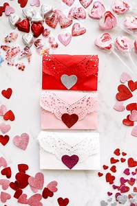 I know the new year has just begun, but I’ve had Valentine’s Day on my mind for some time now. And while it might seem early, for planners, there is no such thing as too early! For our wedding (nearly 12 years ago), we used dollies in various ways, from the invitations to the popcorn snack bar. And since Valentine’s is right around the corner, I thought it would be fun to create these DIY Heart Doily Envelopes while reminiscing about all the doilies we used all those years ago. I bought most of 
