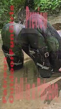 A girl in neoprene pants and a jacket plays in the mud