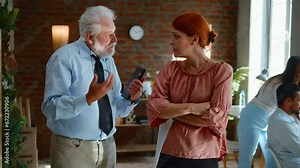 Elderly male employee supports upset depressed female co-worker colleague. Old business man comforting sad woman at work.