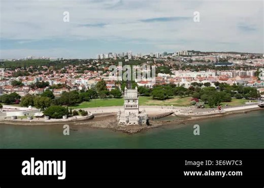 Aerial drone view of Belem Tower on Tagus River overlooking Lisbon showing historic architecture, waterfront, and urban cityscape in bright daylight Stock Video Footage - Alamy