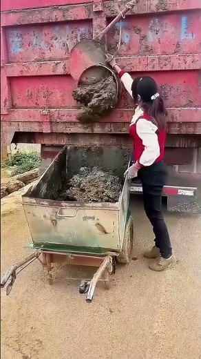 Truck Unloading Scene: Woman Skilfully Handles Materials