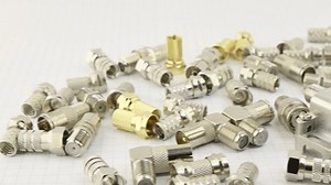 Metal F-connectors for connecting coaxial cable. Close-up. Soft focus.