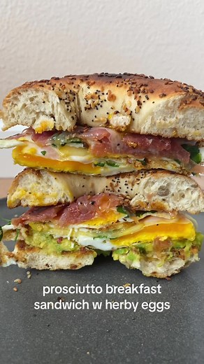 another day, another breakfast sammy slay ⚡️ everything bagel, avo, red pepper flakes, herby fried eggs, raw cheddar, hot sauce, prosciutto • • • #breakfast #bagelsandwich #eggs #sammy