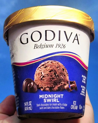 Behold, GODIVA Midnight Swirl Ice Cream! Our dark chocolate ice cream is blended with a fudge swirl and dark chocolatey flakes. 😋 📷 by @snackskies | GODIVA